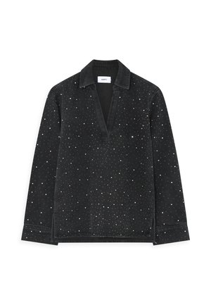 Mustaga pika varrukaga särk V-kaelusega, millel on üle kogu pinna hajutatud valged täpid. Valmistatud pehmest kangast, millel on krae ja külgedel lõhikud.