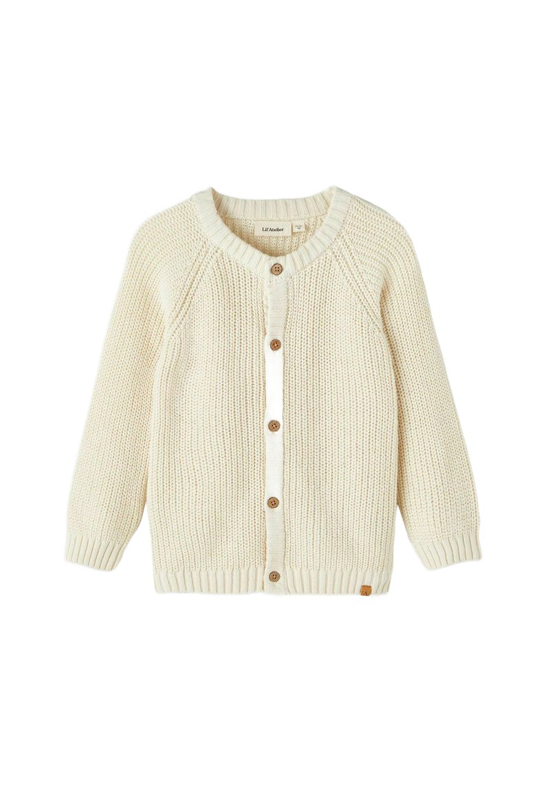 Kreminė megzta kardiganas su apvaliu kaklu, raglanų rankovėmis, mediniais mygtukais ir gumuluotais rankogaliais. Paprasta tekstūra ir švarus dizainas.
