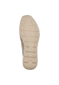 Shoe outsole featuring a textured beige rubber surface with horizontal and vertical grooves, rounded heel, and branding detail.