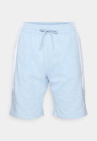 Light blue athletic shorts with white side panels, elastic waistband, drawstring, and embroidered logo on the hem. Soft fabric texture.