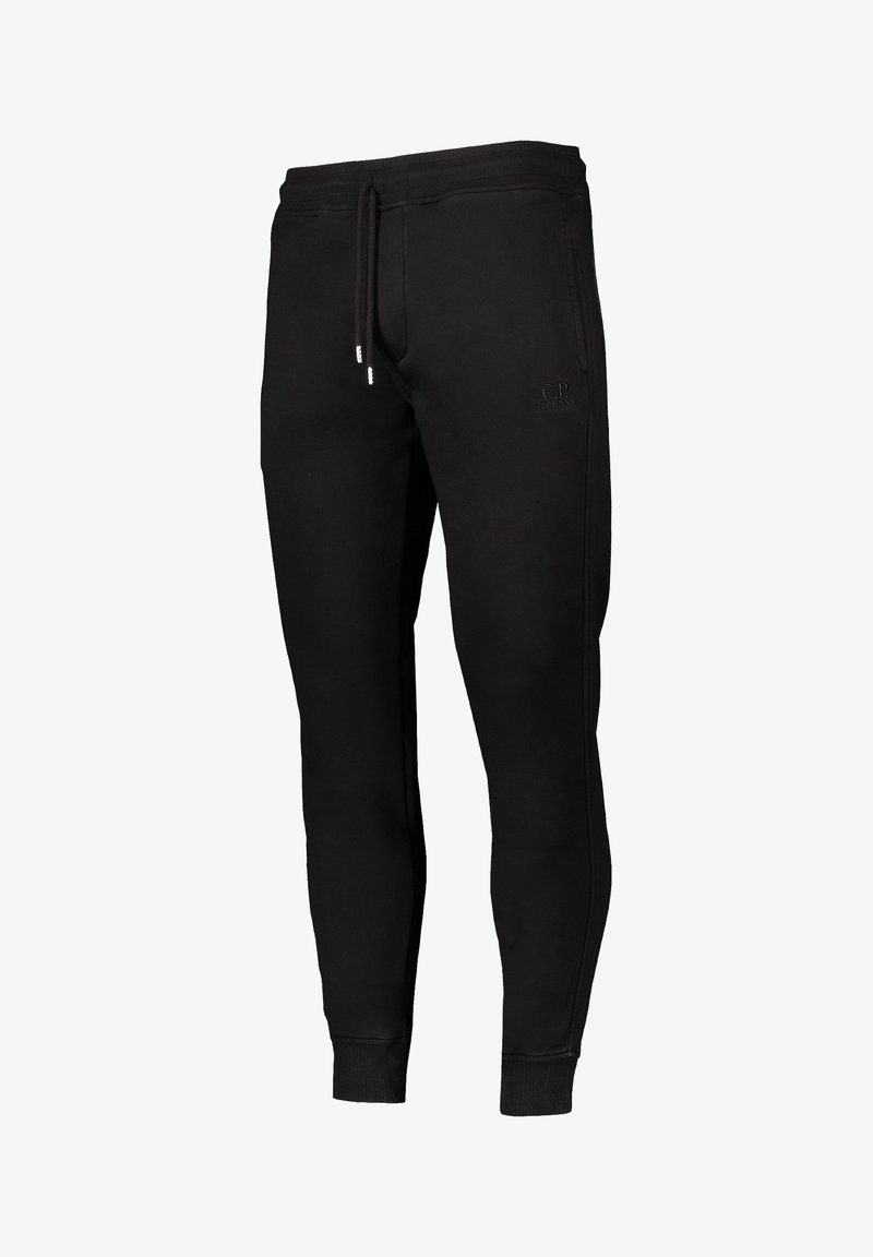 Schwarze Baumwoll-Jogginghose mit schmaler Passform, elastischem Bund, Kordelzug und seitlichen Nähten. Mit geprägtem Logo-Detail auf dem Oberschenkel.