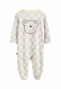 Fußsack für Babys aus weichem Stoff mit einem beigen und grauen Karomuster und einem Bärenkopf-Graphic auf der Rückseite.