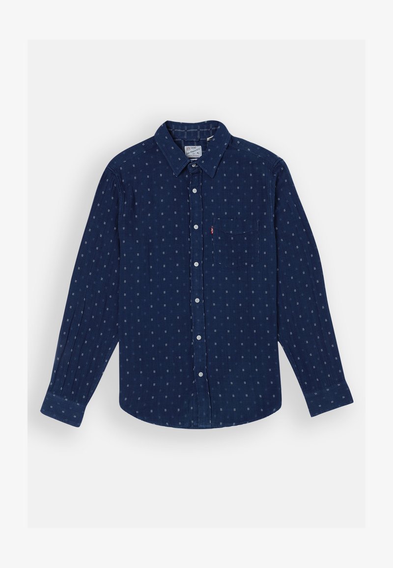 Camicia a maniche lunghe blu navy con motivi geometrici bianchi, colletto a punta, una tasca sul petto e chiusura frontale con bottoni.
