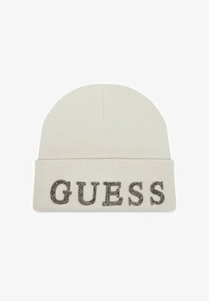 Beanie lavorato a maglia color crema con risvolto. Presenta la scritta "GUESS" in lettere metalliche argentate sul davanti. Morbido al tatto e con una vestibilità aderente.