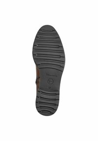 Black rubber shoe sole with textured grooves, featuring a semi-circular logo and size 37, designed for durability and traction.