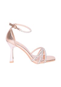I sandali con tacco alto color oro rosa presentano un cinturino alla caviglia con un accento di strass scintillanti e un design a punta. Finitura metallica liscia.