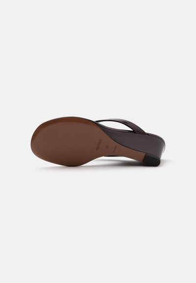 Brown sole of a dark brown heeled sandal with thin straps, size 37, displayed on a plain light background.