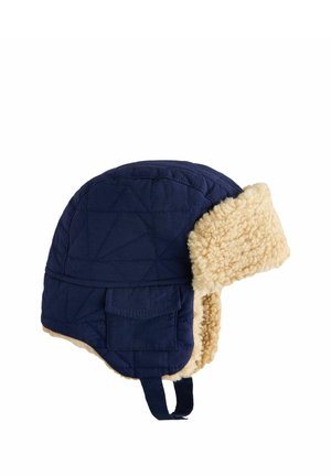 Navy blue quilted winter hat with beige fleece lining, ear flaps, a small pocket, and a chin strap.