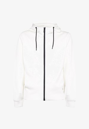 Biała bluza z kapturem na zamek z czarnym zamkiem i czarnymi troczkami, długie rękawy i widoczna przednia prawa kieszeń.