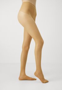 Sheer beige tights with a semi-opaque waistband, smooth texture, and subtle ribbed detailing on the top section.