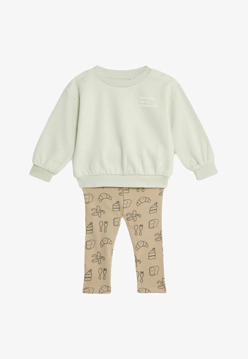 Felpa in cotone verde chiaro con polsini elasticizzati e testo "I croissant sono per la DOMENICA". Leggings beige con una stampa di cibo in marrone.