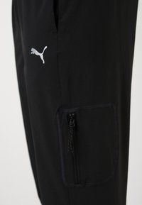 Puma FLEX CARGO PANT - Pantalon de survêtement - black