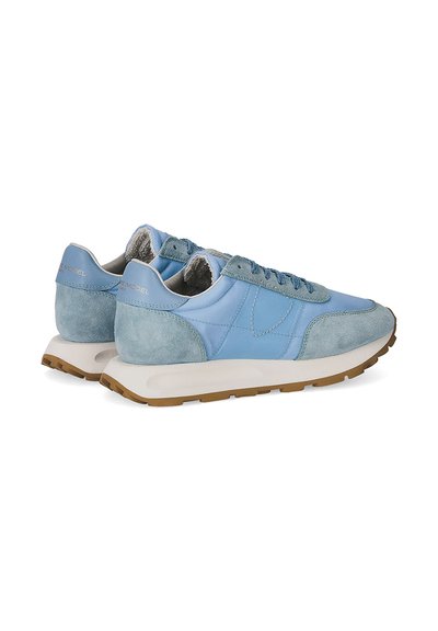 Light blue sneakers with suede and leather materials, featuring a cushioned white midsole, brown rubber outsole, and flat laces.