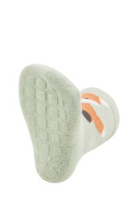 Green sock featuring a fox design, textured bottom with square patterns for grip, and soft, knitted fabric. Clearly marked with a logo.
