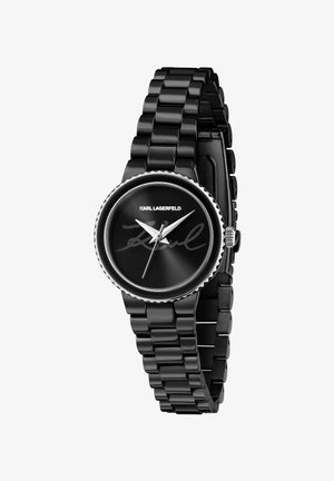 Zwarte horloge met een glanzende metalen band. Rond wijzerplaat heeft een zwarte wijzerplaat met zilveren wijzers en de handtekening van Karl Lagerfeld. Getextureerde lunetteaccenten.