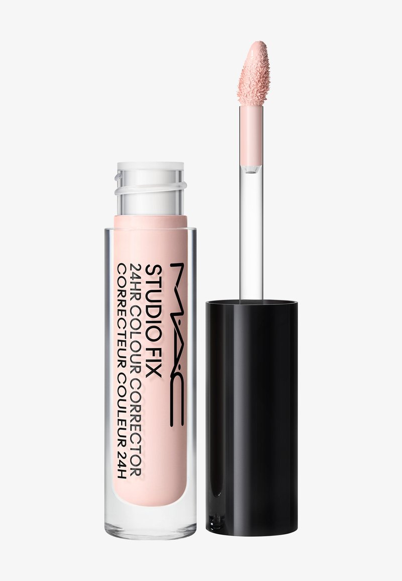 Correcteur de couleur MAC Studio Fix 24 heures dans un tube transparent avec produit rose pâle et bouchon noir avec applicateur bâtonnet.