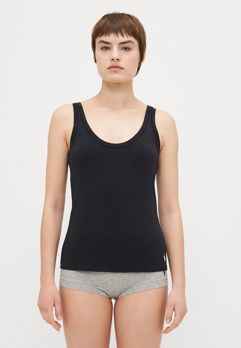 Black sleeveless tank top with a scoop neckline, made from a smooth, stretchy fabric, featuring a small logo at the hem.