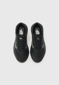 Black sneakers with a breathable mesh upper, round toe, lace-up design, and a grey accent stripe. Features Vans branding on the tongue.