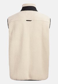 Gilet in pile crema con colletto nero. Presenta una superficie testurizzata e un design con yoke sul retro. Senza maniche, forma slanciata.