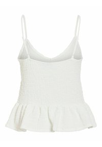 Haut blanc sans manches texturé avec fines bretelles réglables et un ourlet à volants en bas.