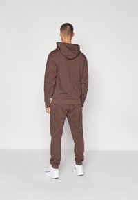 Nike Performance HERITAGE PANT - Trainingsbroek - baroque brown