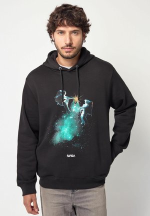 Black hoodie featuring a cosmic design with astronauts and teal accents, made of soft material; includes NASA logo at the bottom.