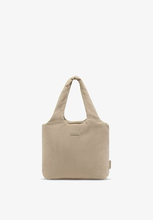 Sac cabas en velours côtelé beige avec de larges anses et une petite étiquette rectangulaire de marque centrée à l'avant.