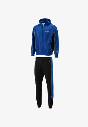 Tuta Champion blu e nera con giacca con cappuccio e zip e pantaloni abbinati con patch logo su petto, manica e coscia.
