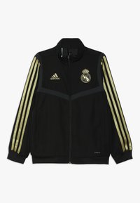 Black Adidas zip-up jacket with gold stripes on sleeves, Real Madrid logo on chest, and "Climalite" text near hem.