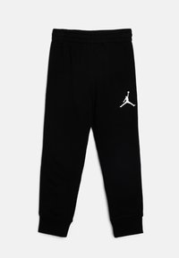 Black jogger pants made of soft material, featuring a white Jordan logo on the left side, with an elastic waistband and tapered cuffs.