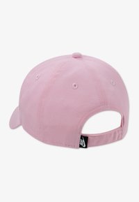 Ροζ καπέλο από βαμβάκι με καμπυλωτή γείσο, ρυθμιζόμενο λουράκι στο πίσω μέρος και κεντητές τρύπες αερισμού. Διαθέτει μικρή ετικέτα με λογότυπο.