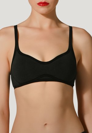 Bralette noir avec des bretelles fines et ajustables, en tissu doux et avec une finition lisse. Dotée d'un décolleté courbé et de détails de coutures subtils.