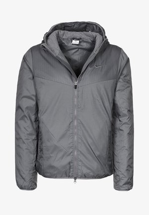 Veste à capuche grise Nike avec fermeture éclair frontale complète, panneau texturé sur la partie supérieure de la poitrine et doublure intérieure douce.