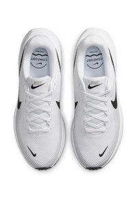 Zapatillas deportivas blancas de Nike con parte superior de malla, acentos en negro, cierre de cordones y un collar acolchado. La plantilla presenta un logo de "Comfort".