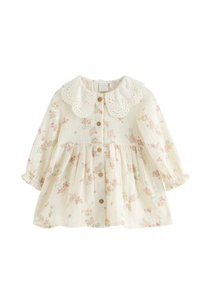 Baby kjole i cremefarve med lange ærmer, træknapper foran, hulmønsteret bølget krave og pastelblomstret print.