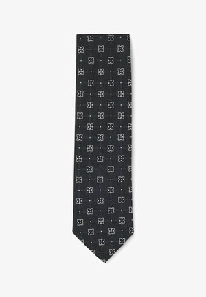 Zwarte stropdas met een herhalend wit geometrisch patroon van vierkanten en kruizen, gemaakt van gladde stof met een puntige eind.