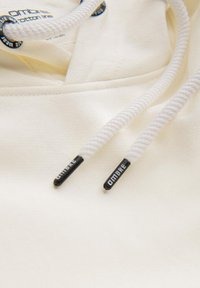 Katoenen hoodie in crème kleur met een gestructureerde afwerking. Voorzien van witte aantrekkoorden met zwarte plastic punten gelabeld "OMBRE."