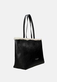 Borsa tote in pelle nera con finiture in shearling bianco e doppi manici, con piccolo logo argento del marchio sul davanti.