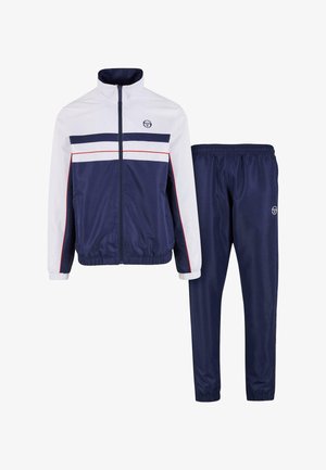 Tuta da ginnastica blu navy con giacca con zip caratterizzata da strisce orizzontali bianche e rosse, polsini elastici e pantaloni abbinati con vita elastica.