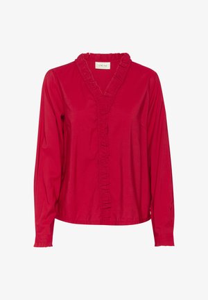 Röd långärmad blus i lättviktsmaterial, med en volangad V-halsringning och en placket med volangdetaljer längs framsidan.