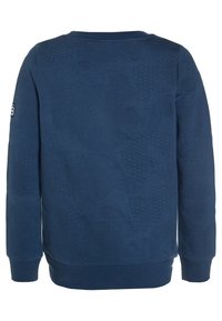 Felpa a maniche lunghe blu navy con motivi testurizzati, polsini e orlo a coste, e una piccola toppa con logo sulla manica sinistra.