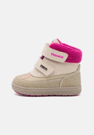 Beige winter boot with pink accents, textured surface, fuzzy collar, double Velcro straps, and a rubber sole with traction pattern.