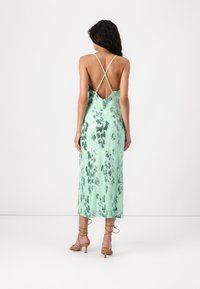 Minzgrünes Blumenkleid mit Spaghettiträgern, offener Rückseite und knielangem Saum. Verfügt über eine weiche, fließende Textur und einen dezenten Glanz.