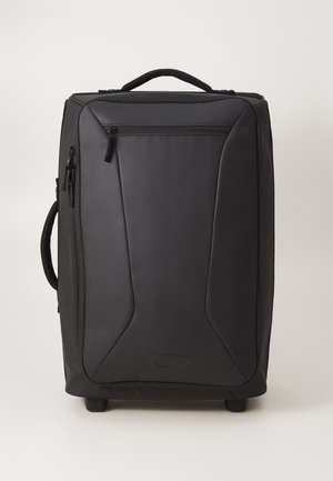 Rolling black luggage with a smooth synthetic exterior, zippered pockets, a top handle, and wheels for mobility. Features a sleek, angled design.