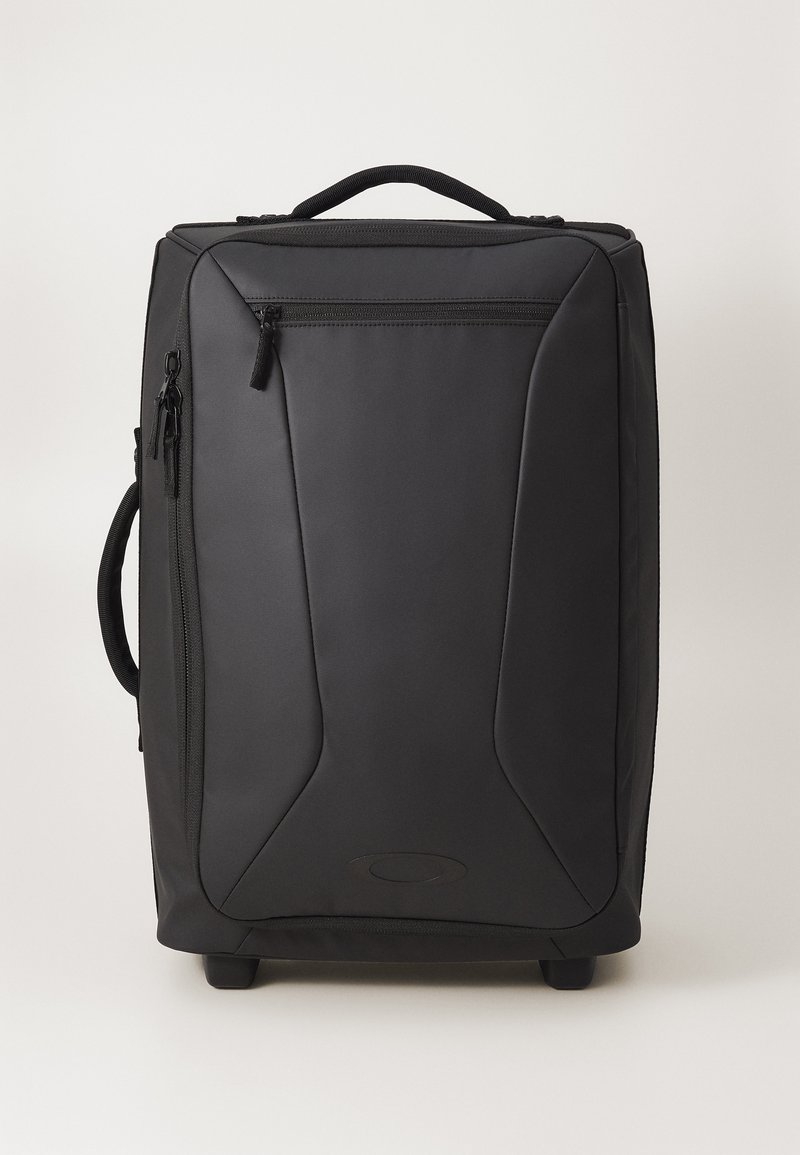 Rolling black luggage with a smooth synthetic exterior, zippered pockets, a top handle, and wheels for mobility. Features a sleek, angled design.