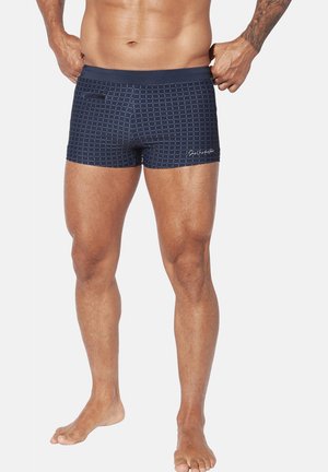 Navy swim shorts featuring a grid pattern, elastic waistband, and a small side pocket. Smooth fabric with a fitted design.