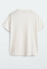 T-shirt blanc uni à manches courtes, vu de dos, avec un col ras du cou et une couture décorative subtile sur les coutures des épaules.