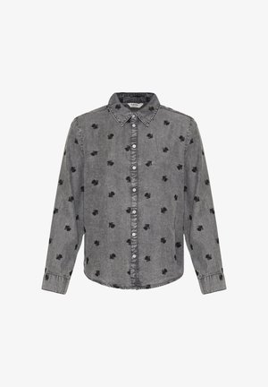 Pelēka kokvilnas krekls ar pogām, melnas lapu izšuvumi, apkakle, garām piedurknēm un izliektas apakšmalas. Aprīkots ar metāla pogu aizdari.