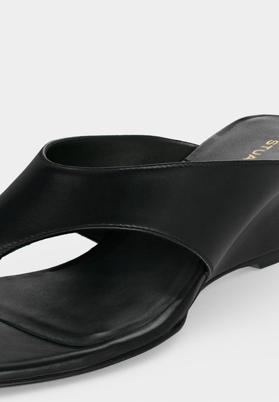 Sandale noire en cuir à enfiler avec larges brides croisées, talon compensé bas, bout ouvert et semelle rembourrée.