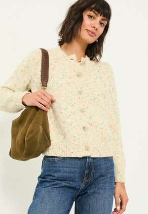 Knitted cream cardigan with multicolored speckles, round neck, and button closure. Paired with blue jeans and a brown suede bag.